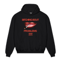 Black hoodie featuring red lips holding a cigarette, with red “Bitching bout” text above, red “problems” text below, and smaller red-and-black “Parental Advisory – Skye Newman” print underneath.